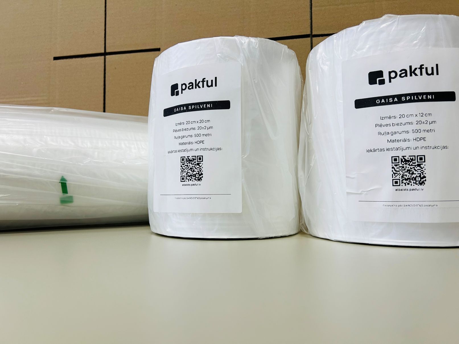 Two Pakful HDPE air cushion rolls on a warehouse table with product labels.