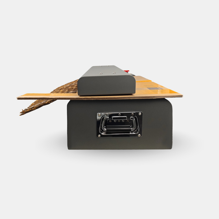 Rear view of X72 cardboard shredder showing metal housing and waste collection system